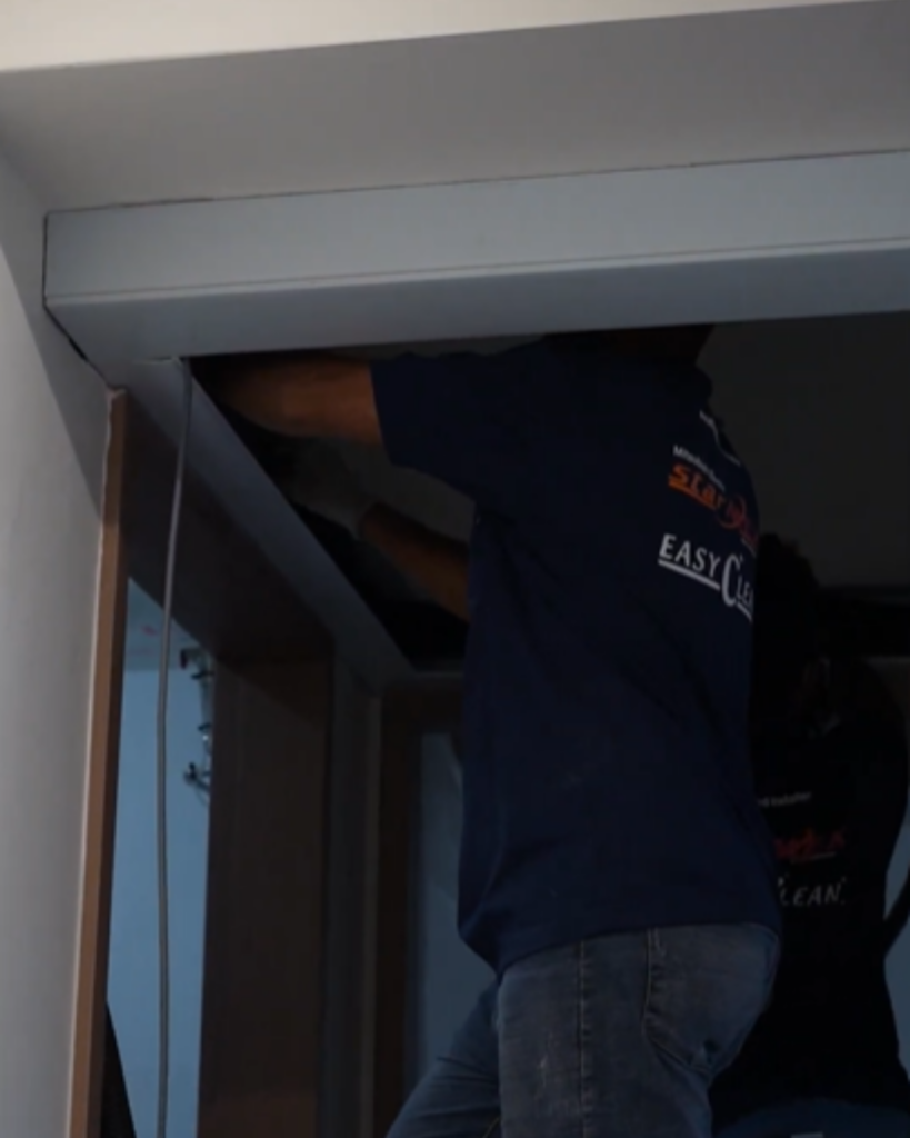 EASY Clean technician accessing interior components of air conditioning unit