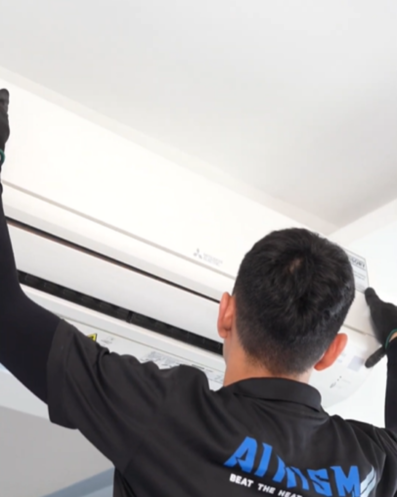 AIRISM technician cleaning filters of wall-mounted air conditioner